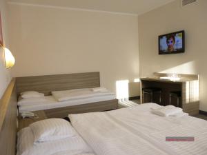 Łóżko lub łóżka w pokoju w obiekcie Paprika M1 Hotel
