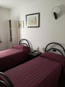 Postel nebo postele na pokoji v ubytování 3 Tesori B&B
