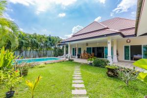 a backyard with a pool and a house at Pacotte Villa by G Estate in Rawai Beach