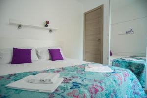 a hotel room with a bed with towels on it at Apartments Svijet Mora in Povljana
