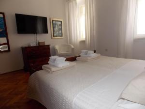 En eller flere senge i et værelse på Corte dei merli Apartments