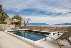 a swimming pool with a view of the water at Apartment Di Blu in Novi Vinodolski