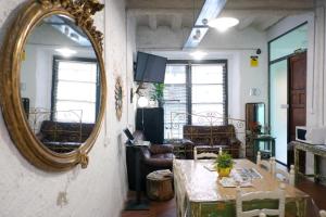 a living room with a mirror and a table at Pigal in Tarragona