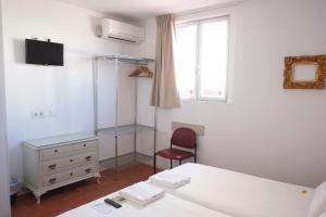 a bedroom with two beds and a desk and a chair at Pigal in Tarragona