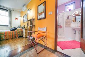 a bathroom with a sink and a chair in a room at Apartments Baredi in Izola +37 photos