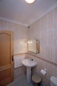 a bathroom with a sink and a mirror at Apartamentos Casanova in Nerja