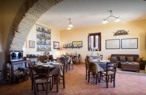 a restaurant with tables and chairs in a room at Villa Palamara 1868-Toweronthesea in SantʼAmbrogio