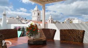 a table and chairs with a view of a city at Infante Guesthouse in Lagos