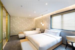 Postel nebo postele na pokoji v ubytování Nampo Hound Hotel Premier