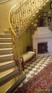 a staircase in a living room with a fireplace at Agriturismo Allo Scoglio - Azienda Agricola in Trieste