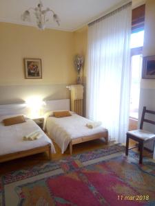 a hotel room with two beds and a window at Agriturismo Allo Scoglio - Azienda Agricola in Trieste