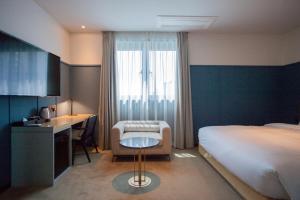 Postel nebo postele na pokoji v ubytování Nampo Hound Hotel Premier