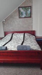 a bed with two pillows on it in a room at Karczma Góralska in Wisznice