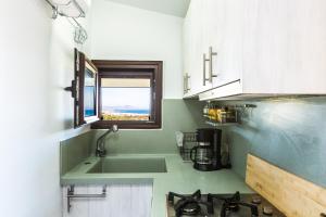 a kitchen with a sink and a window at Evita's Home, a romantic escape, By ThinkVilla in Platanes