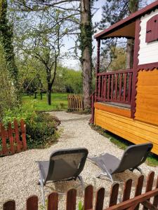 two chairs sitting in front of a house at Roulotte Comtoise à Strasbourg in Strasbourg