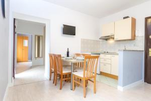a kitchen and dining room with a table and chairs at Apartments in city center Ventus in Novalja +43 photos