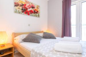 a bedroom with a bed with two pillows on it at Apartments in city center Ventus in Novalja