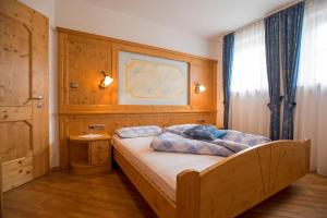 a bedroom with a bed with blue pillows on it at Appartamenti Lercher Anna in San Candido