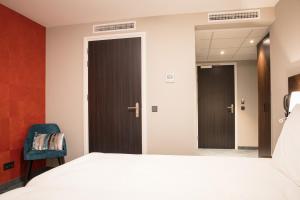 Postel nebo postele na pokoji v ubytování Hotel de Koppelpaarden