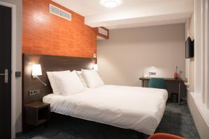 Postel nebo postele na pokoji v ubytování Hotel de Koppelpaarden