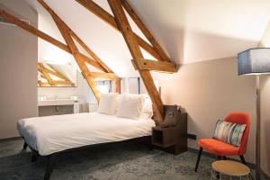 Postel nebo postele na pokoji v ubytování Hotel de Koppelpaarden