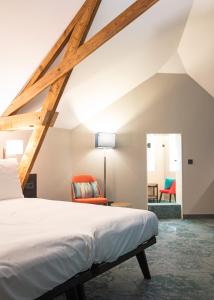 Postel nebo postele na pokoji v ubytování Hotel de Koppelpaarden