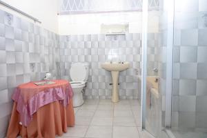 a bathroom with a toilet and a sink and a table at Seabrook 001 - Margate RSA in Margate