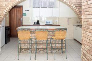 an archway in a kitchen with a counter and chairs at Seabrook 001 - Margate RSA in Margate