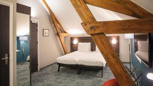 een slaapkamer met een bed in een kamer bij Hotel de Koppelpaarden in Lichtenvoorde