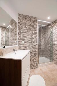 a bathroom with a white sink and a shower at Apartamentos Rivera in Alicante