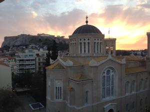 a large building with a dome on top of it at Metropolis Hotel in Athens