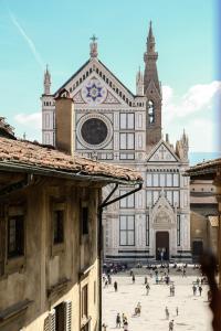 a large building with people walking in front of it at L'Anfiteatro Nascosto in Florence