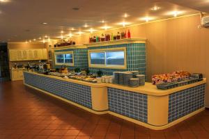 a kitchen with a counter with food on it at Hotel Majestic Mamaia Half Board & All Inclusive in Mamaia