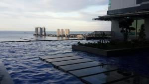 a swimming pool on top of a building with the water at Robert's Condominium in Jakarta