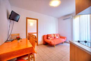a living room with a red chair and a television at Villa D&I in Vodice