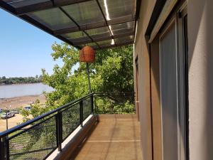 a balcony with a view of a beach at Paraíso Río in Concordia