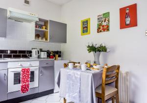 a kitchen with a table with a table cloth at Silver Tides House in Greenock