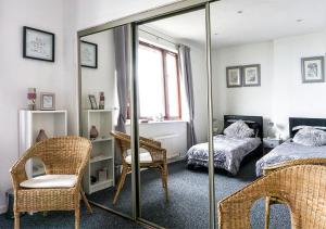 a bedroom with a mirror and a bed at Silver Tides House in Greenock