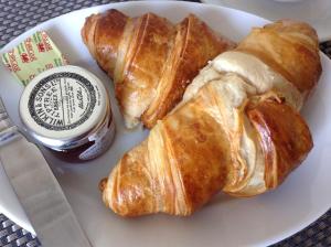 a plate with croissants and a container of jam at Endeavour Guest House in Barmouth