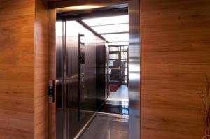 an elevator in a building with wooden walls at Hotel Credé in Kassel