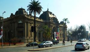 a large building with cars parked in front of it at Apartments Bellas Artes in Santiago
