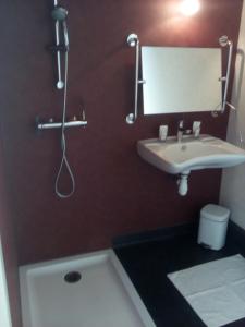 a bathroom with a sink and a shower at Auberge Pen Mur in Muzillac