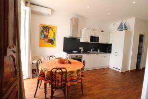 uma cozinha com mesa e cadeiras num quarto em Luxury 1 bedroom Quai St Pierre 2 mins from the Palais & Croisette 269 em Cannes