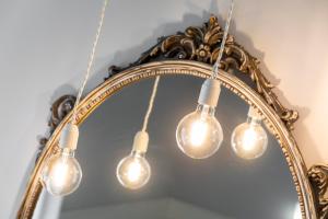 a group of lights in front of a mirror at Hotel Speranza in Bardolino