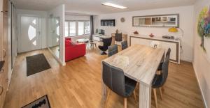 a dining room and living room with a table and chairs at Point Cardinal in Geneva