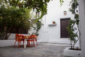 a table and chairs in front of a building at Neroli House in Archangelos