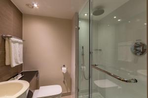 a bathroom with a shower, sink, and toilet at Thistle Trafalgar Square in London