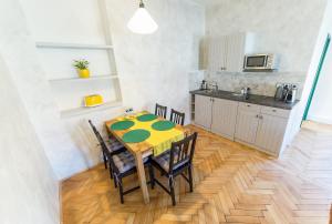 a kitchen and dining room with a table and chairs at Babylon Apartmány in Český Krumlov