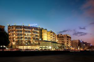 a building with a sony sign on top of it at Savoia Hotel Rimini in Rimini