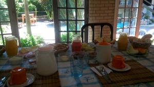 a table with a breakfast of milk and orange juice at Belo recanto in Niterói